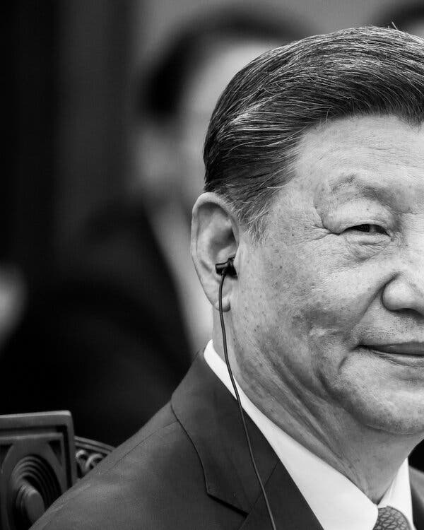 President Xi Jinping of China with an earpiece in one ear.